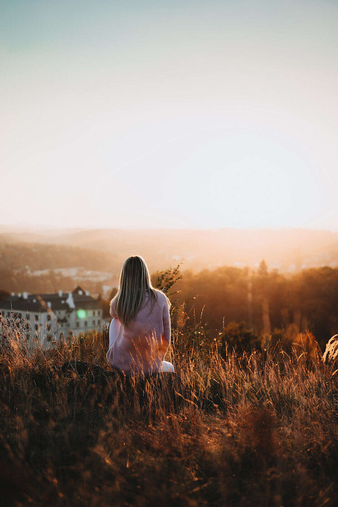 Woman Sitting on a Hill and Looking at The Castle