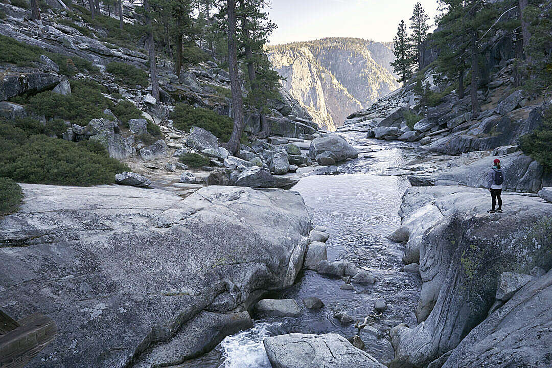 Woman Standing near the Top of the Waterfall in Yosemite National Park