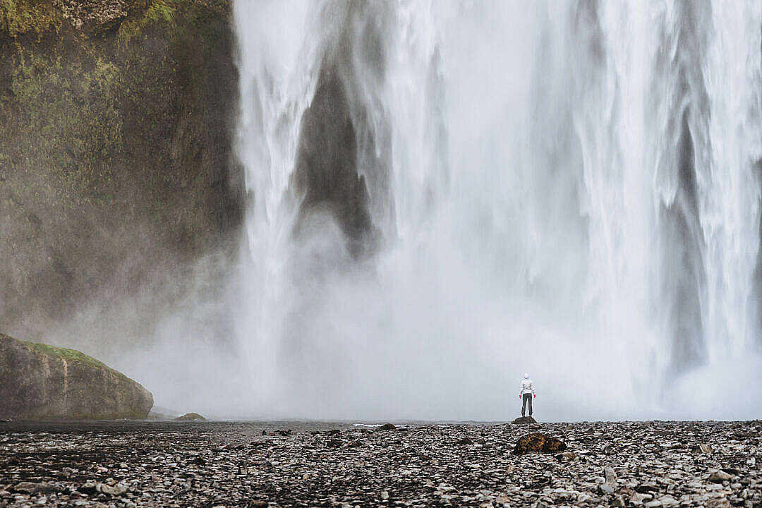 Woman Standing Near Waterfalls