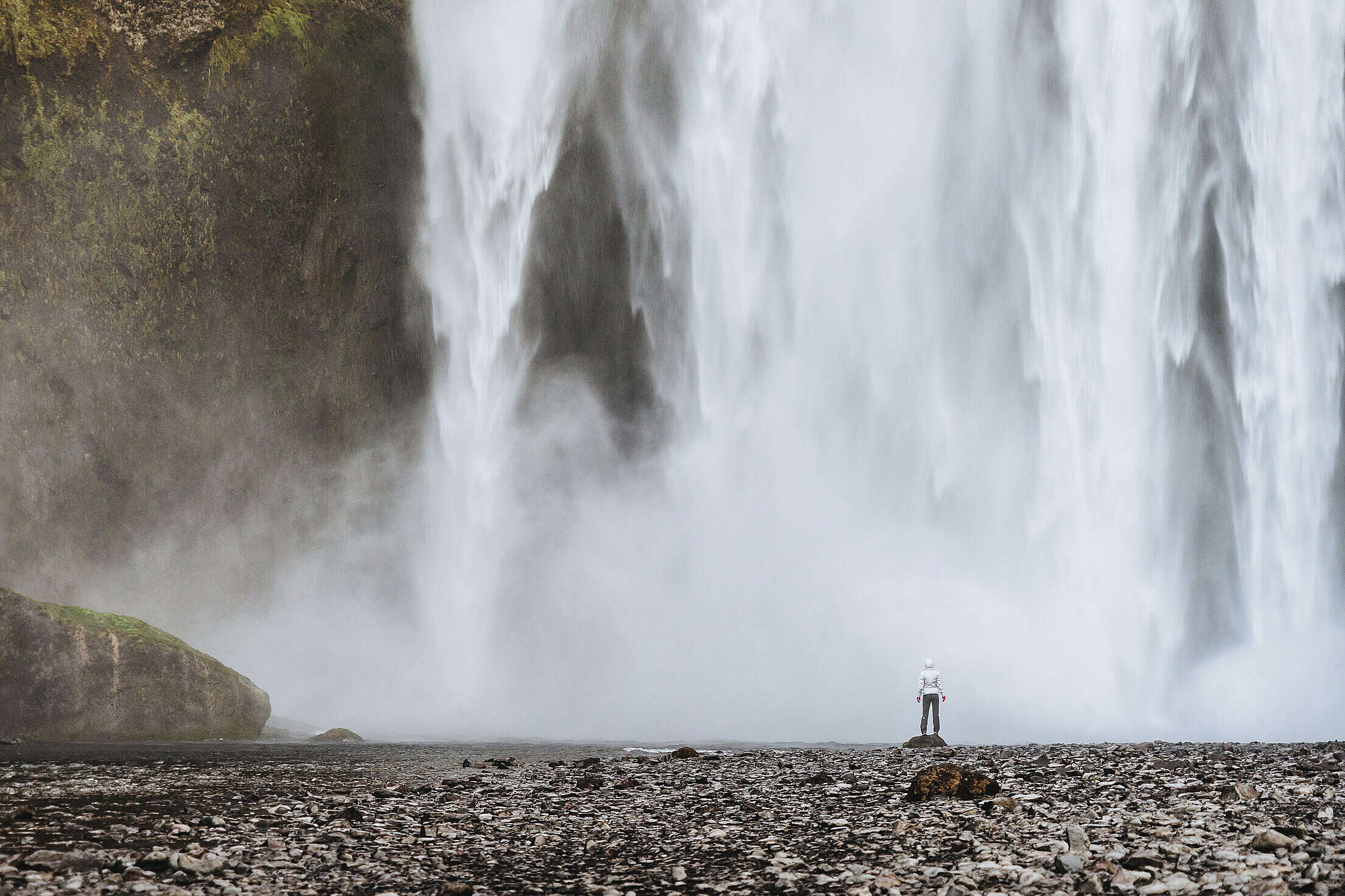 Woman Standing Near Waterfalls Free Stock Photo