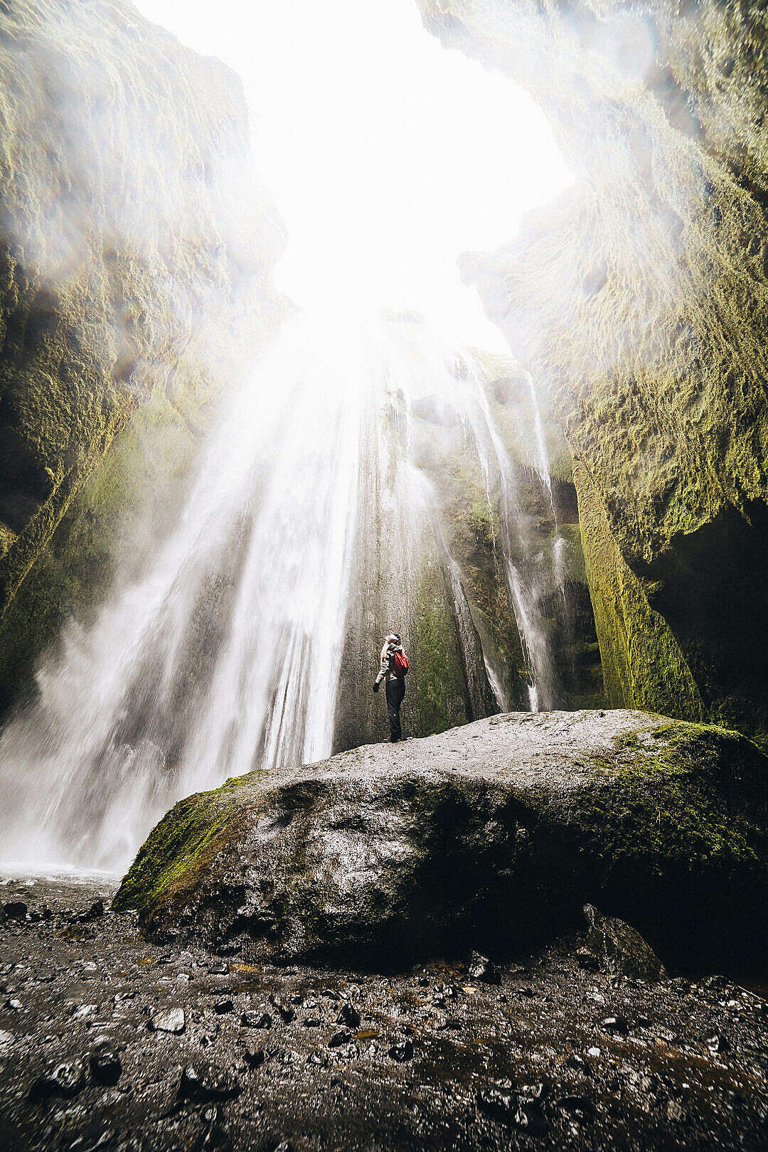 Download Woman Standing Under The Gljúfrabúi Waterfall, Iceland FREE Stock Photo