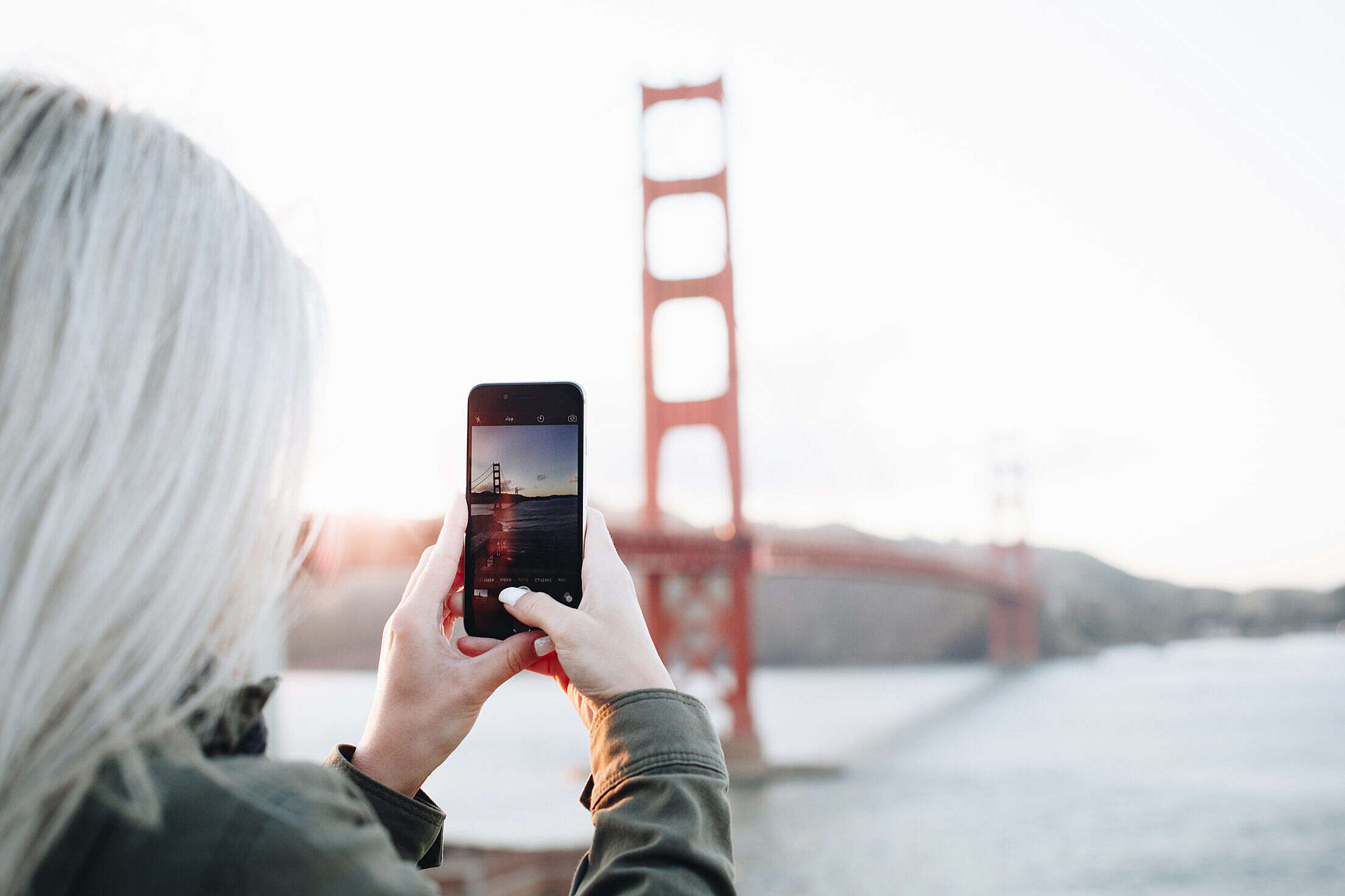 Woman Taking a Photo of The Golden Gate Bridge Free Stock Photo