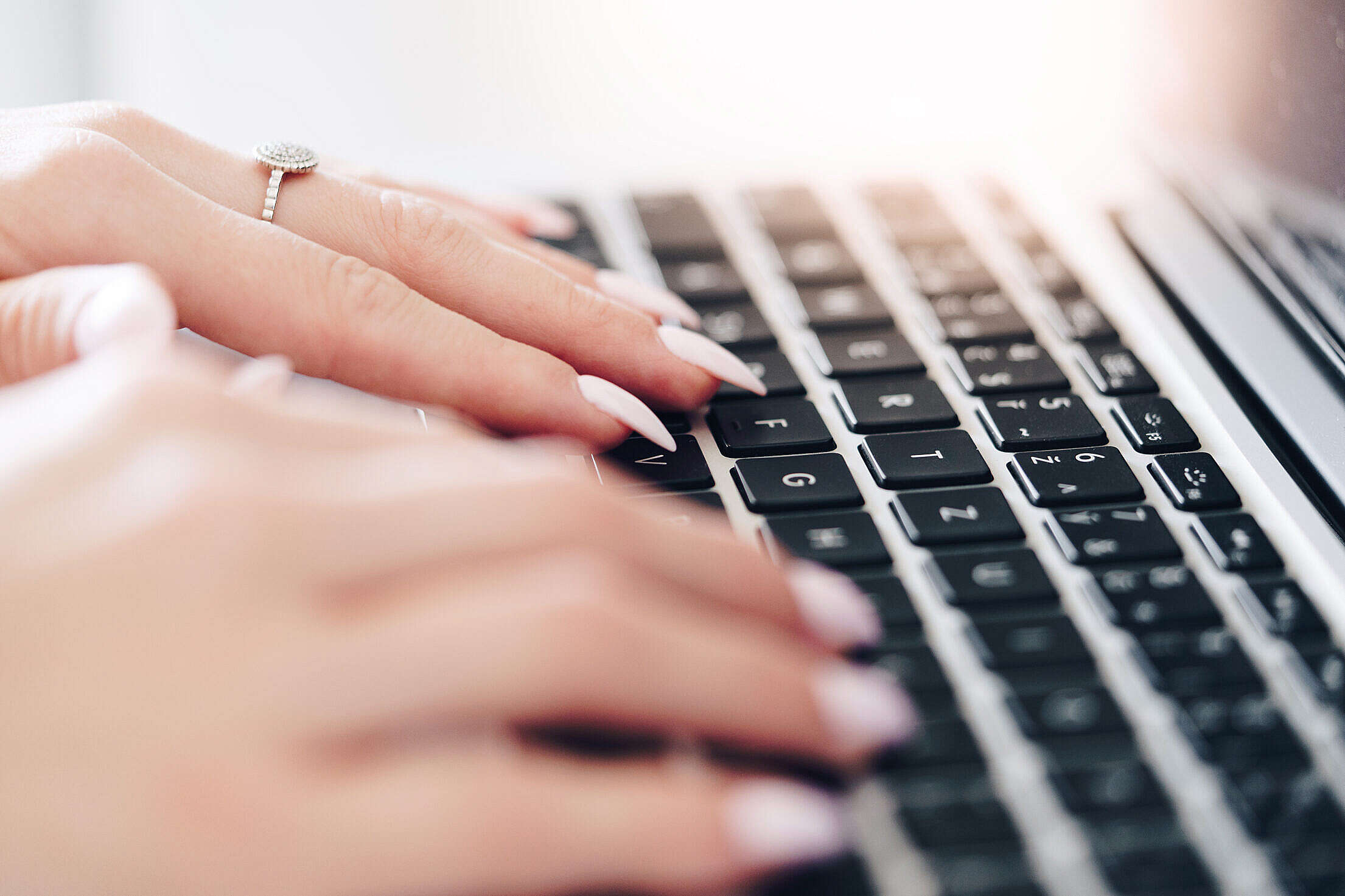 Woman Typing on a Laptop Free Stock Photo