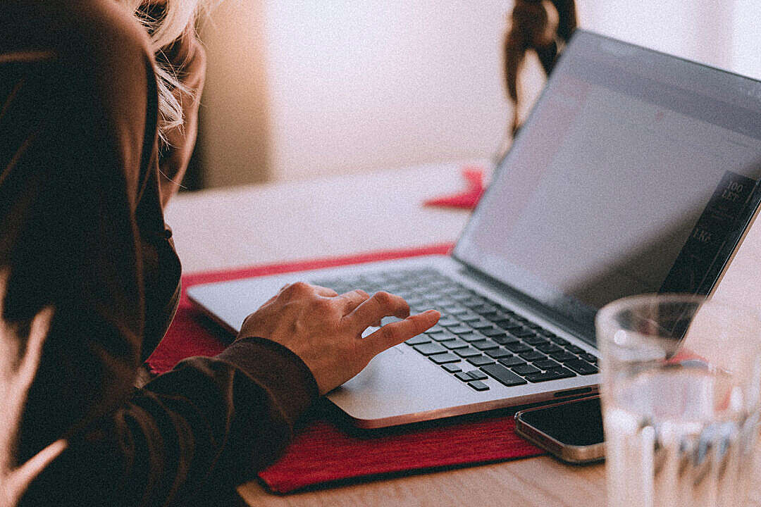 Woman Using Her Laptop Comfortably at Home