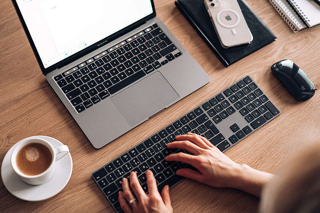 Woman Writing Documents on Laptop with Full Size Keyboard