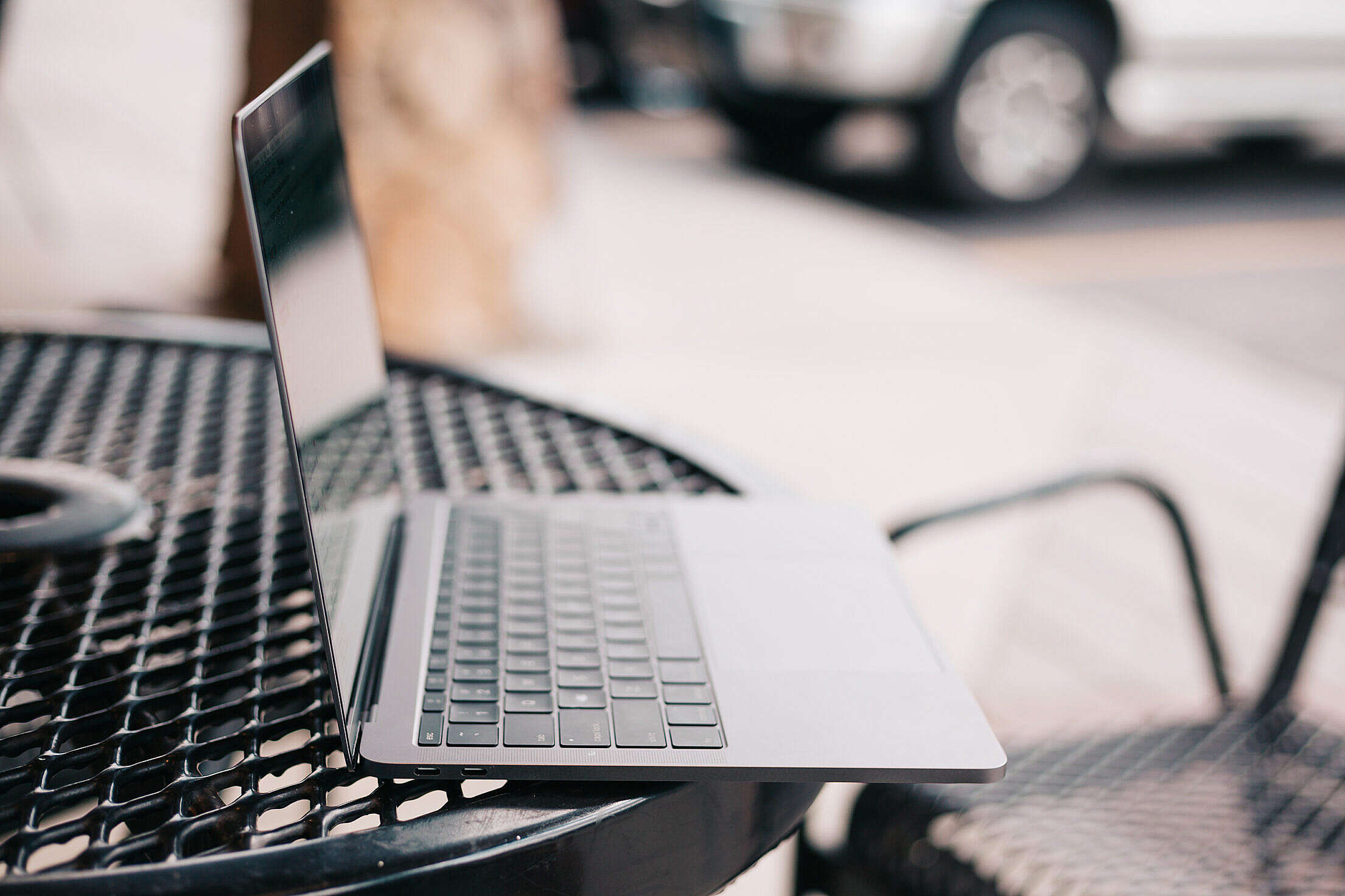 Working on a Laptop Outside on Sunny Evening Free Stock Photo