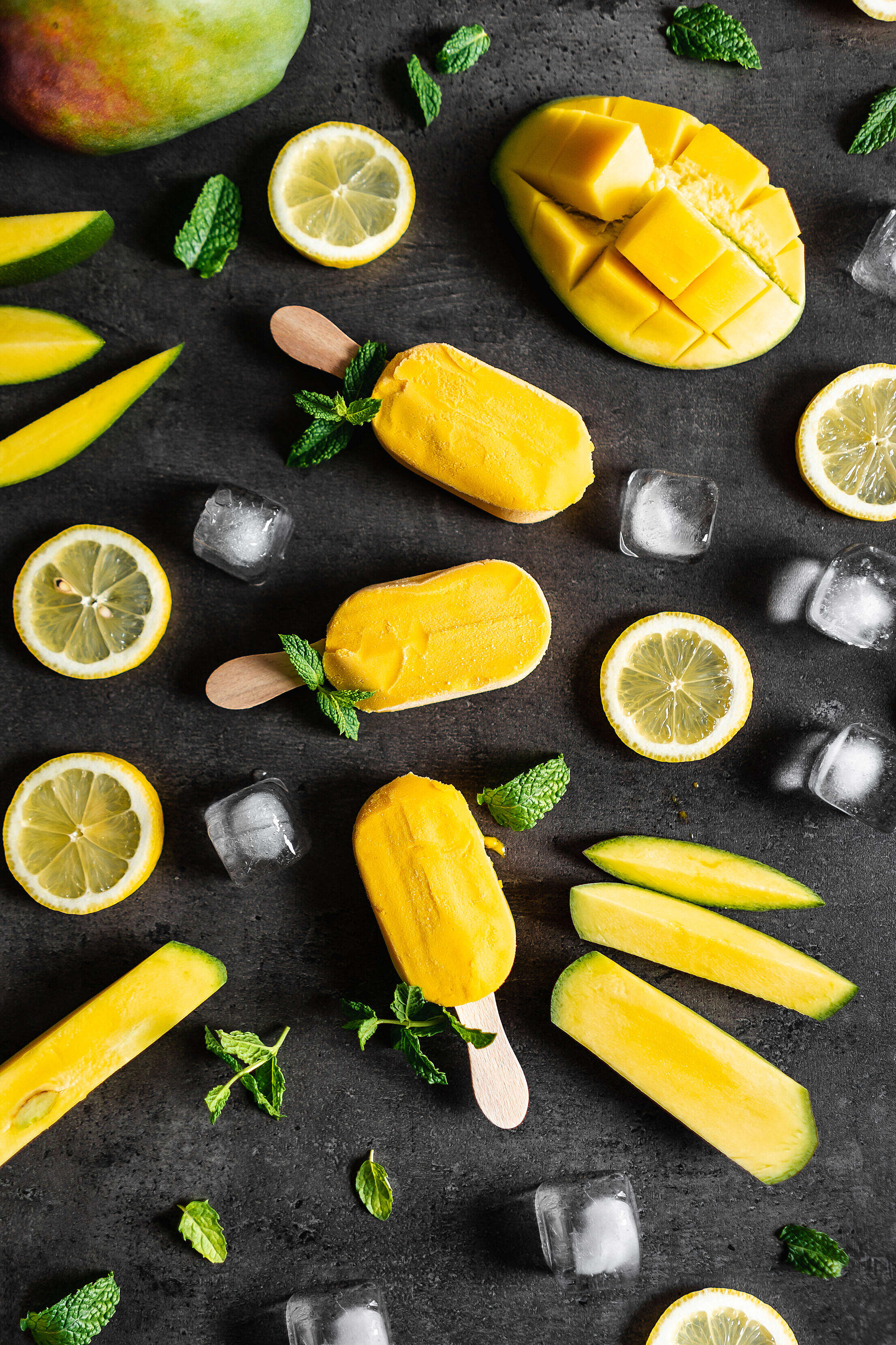 Yellow Popsicles Decorated with Mint Leaves and Fruit Free Stock Photo