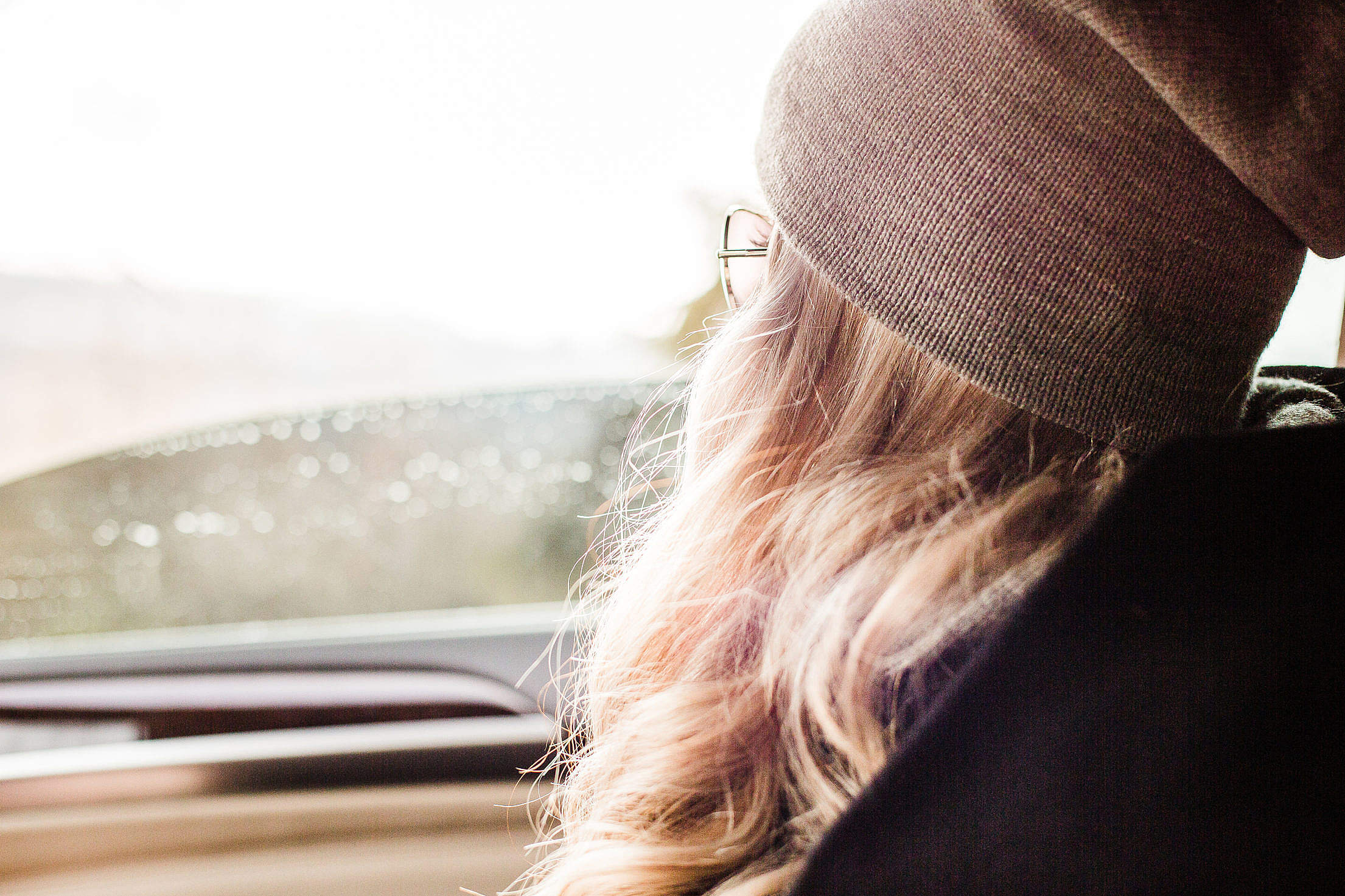 Young & Beautiful Blonde Girl Looking Out of Car Window Free Stock Photo