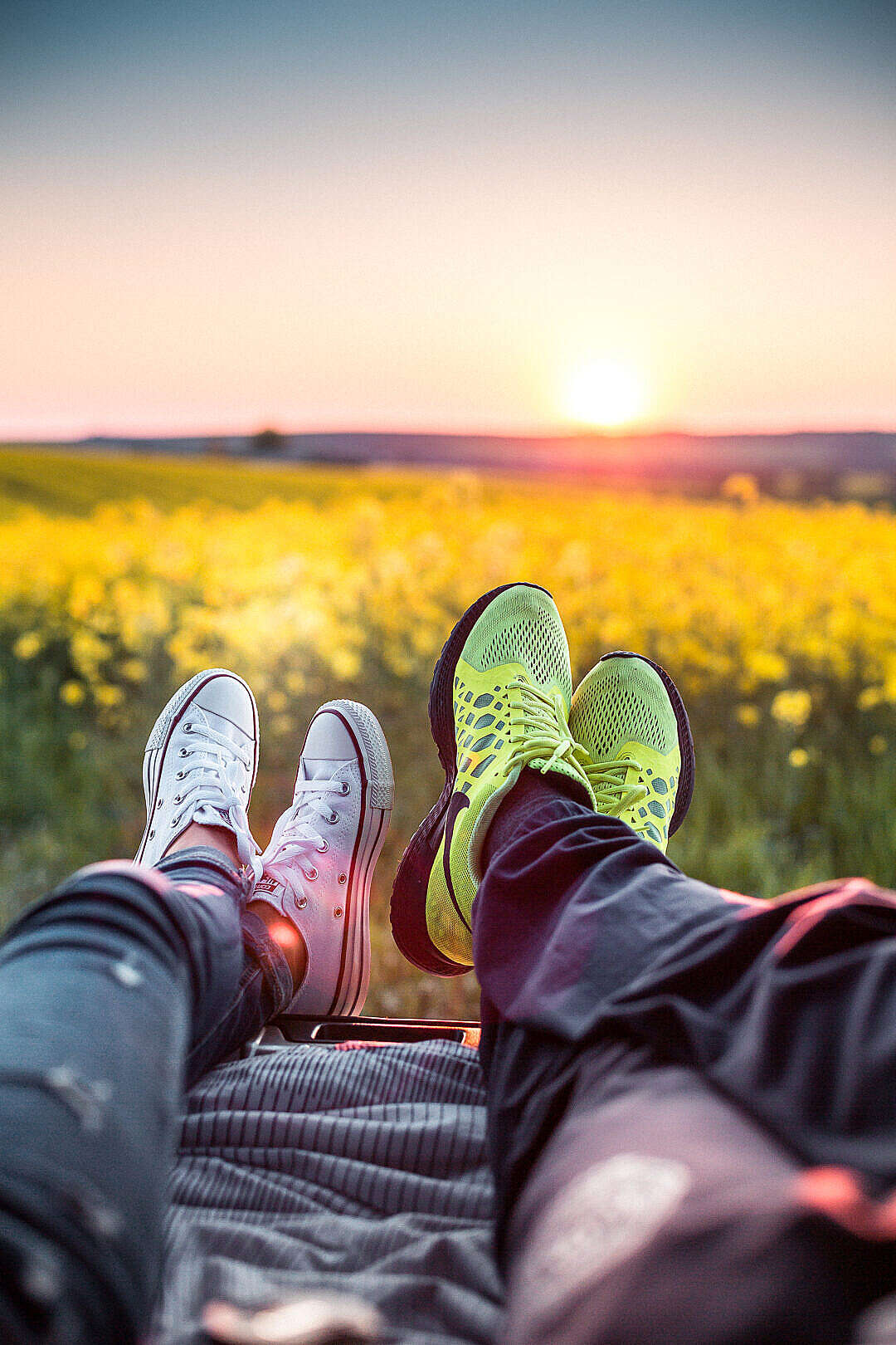 Download Young Couple Enjoying Sunset in a Car Trunk FREE Stock Photo
