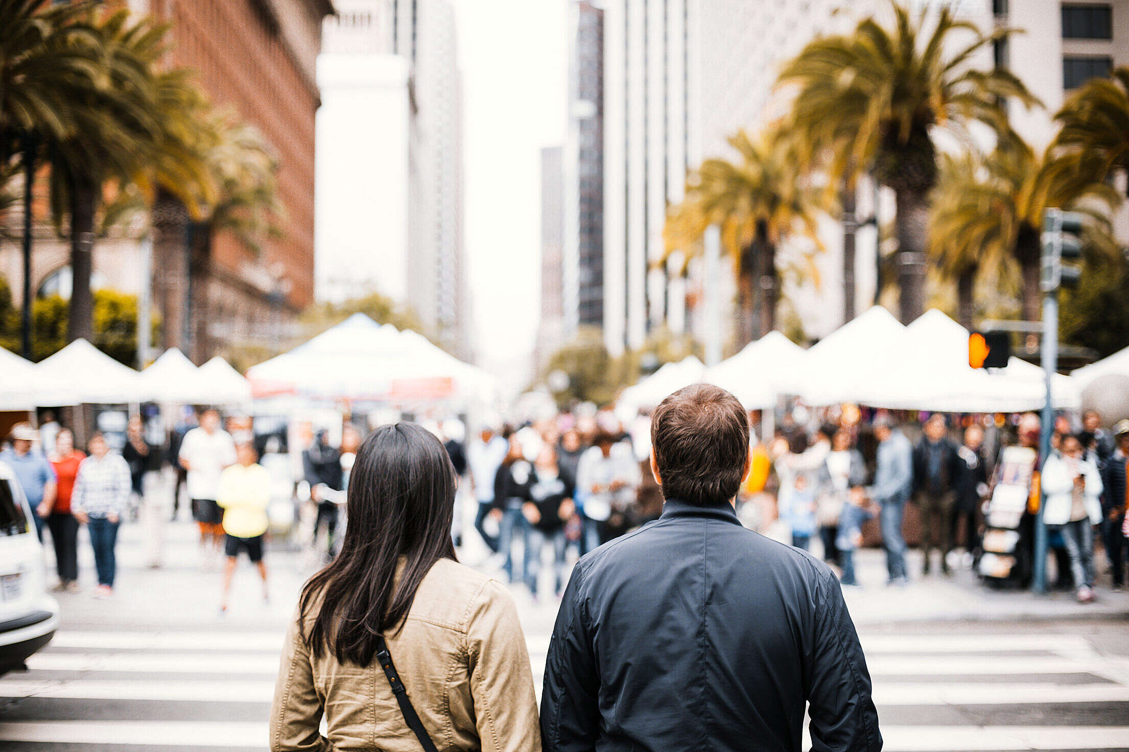 Young Couple Looking on the Other Side of the Crosswalk Free Stock Photo