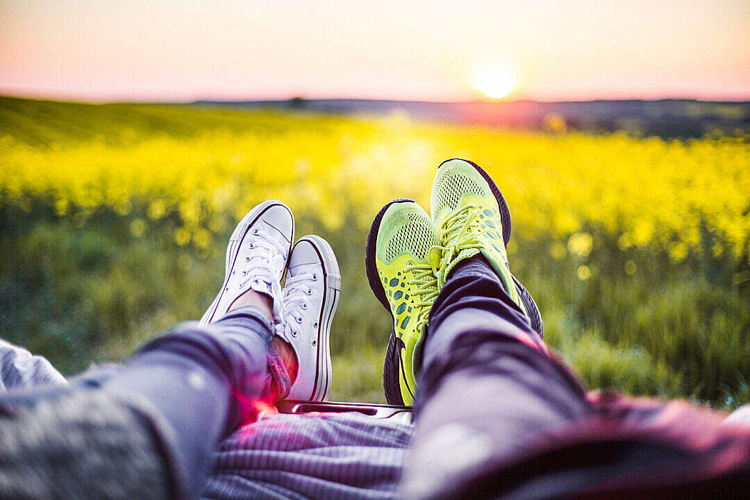 Download Young Couple Relaxing & Enjoying The Sunset from The Car FREE Stock Photo