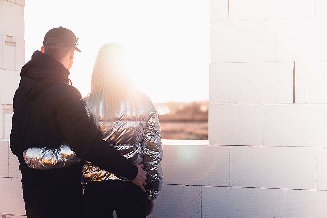 Young Couple Standing on The Construction Site of Their New House