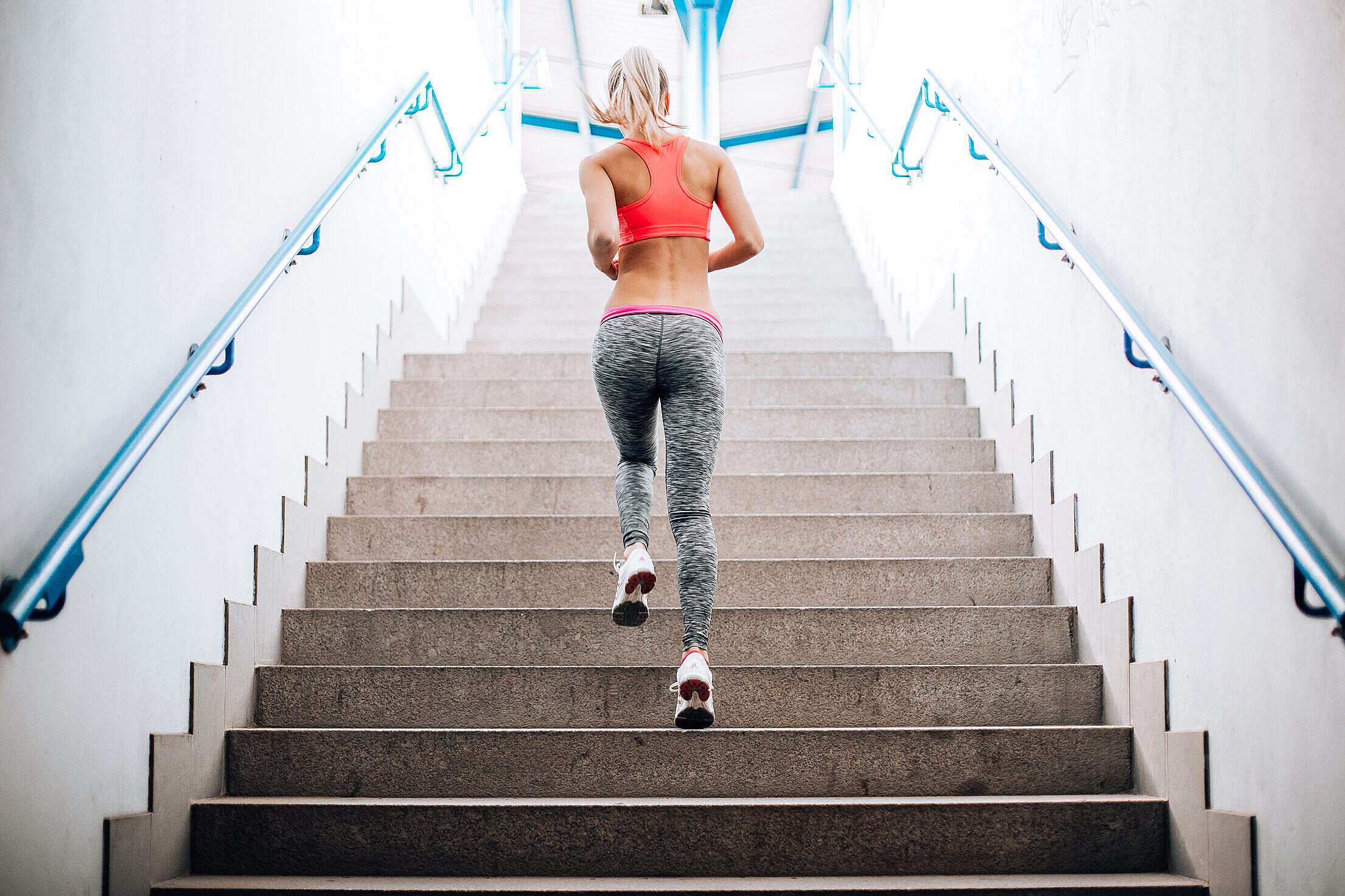 Young Fitness Girl Running Up The Stairs Free Stock Photo