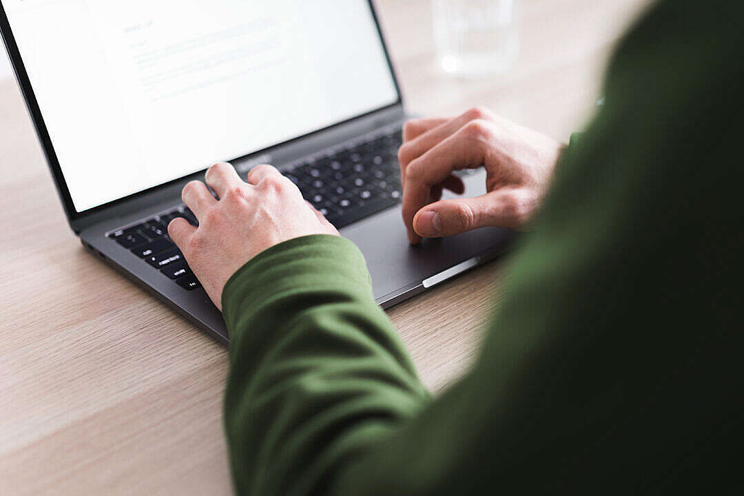 Young Millennial Man Working on His MacBook Laptop