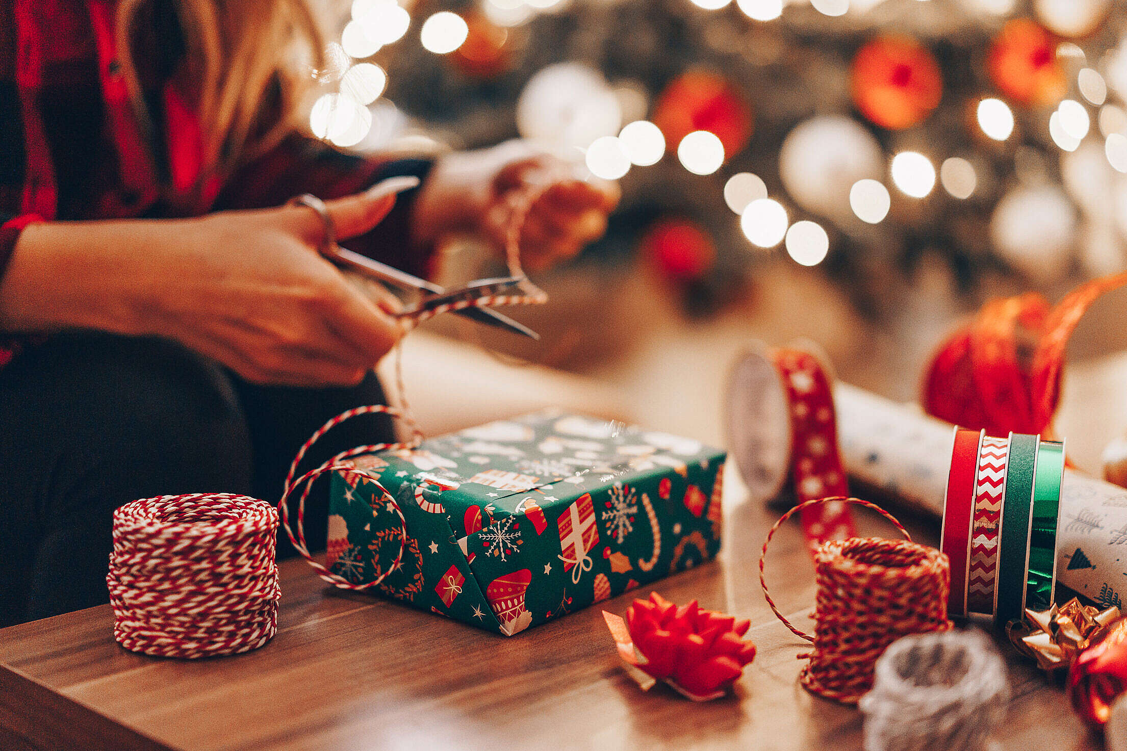 Premium Photo  Closeup image of girl cutting red wrapping paper for  christmas presents