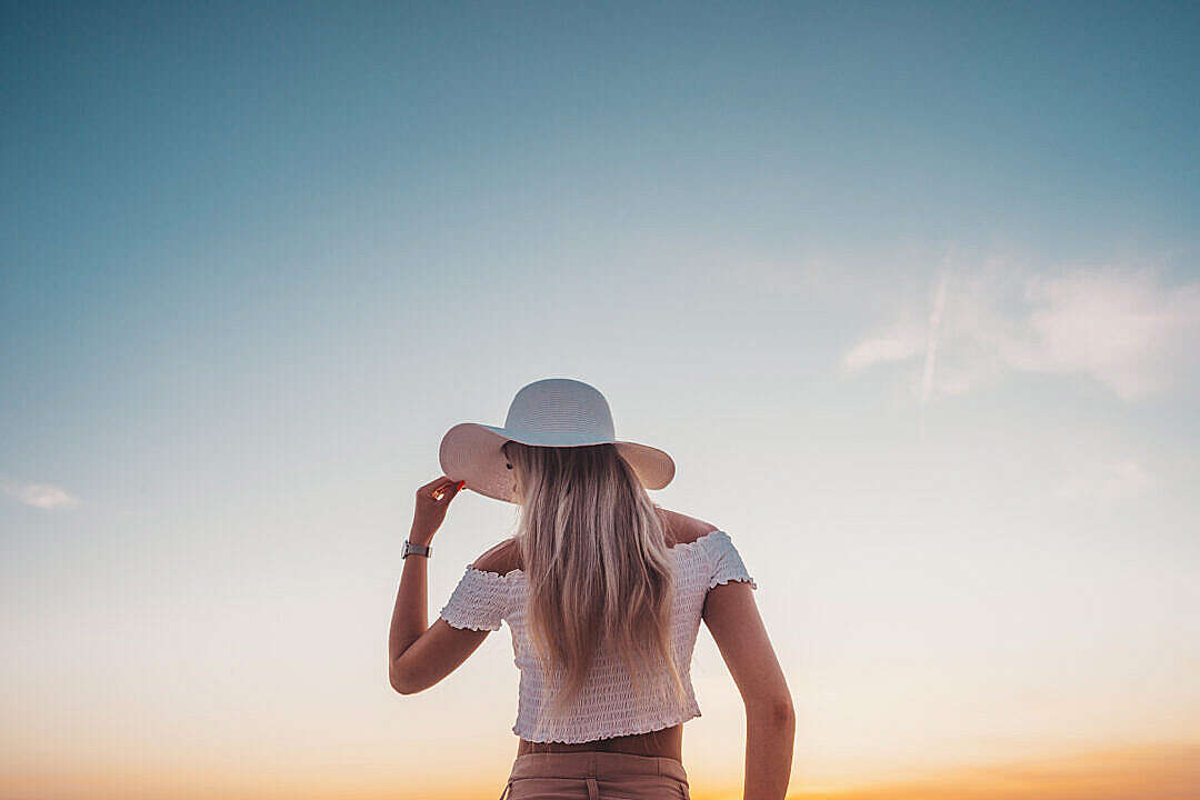 Download Young Woman Against Blue Evening Sky FREE Stock Photo