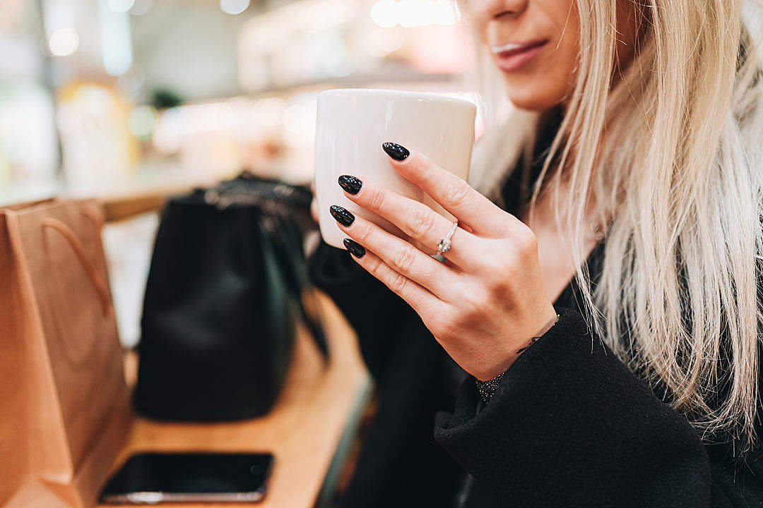 Young Woman Drinking Cappuccino