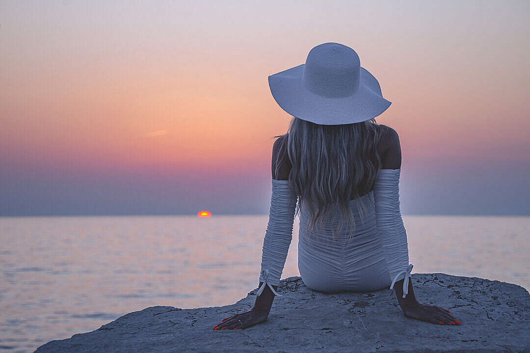 Download Young Woman Enjoying Amazing Sunset FREE Stock Photo