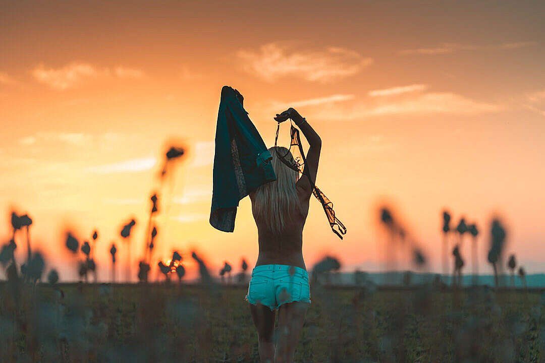 Young Woman Enjoying Freedom and Throwing Her Bra Away