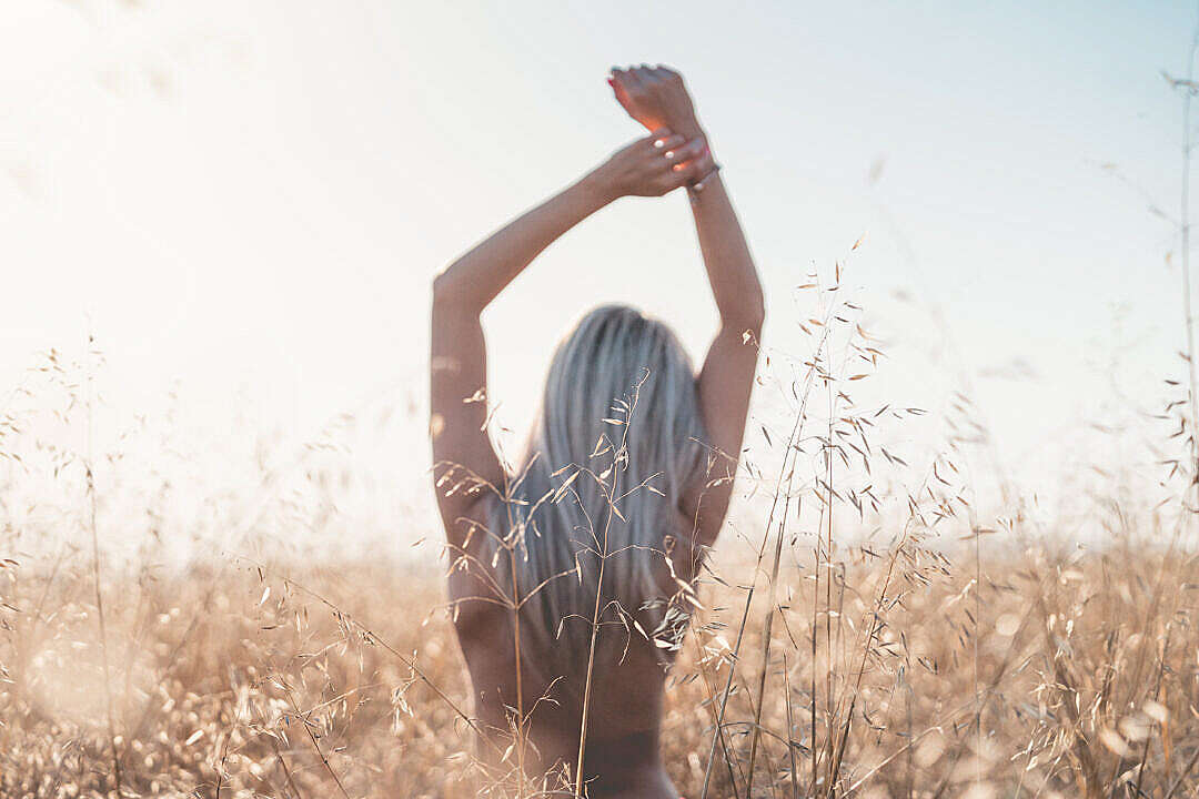 Download Young Woman Enjoying Freedom at Wheat Field FREE Stock Photo