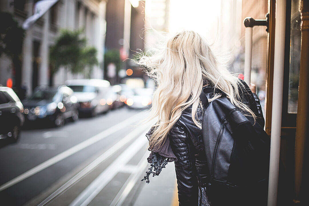 Young Woman Riding The Famous Cable Car in San Francisco