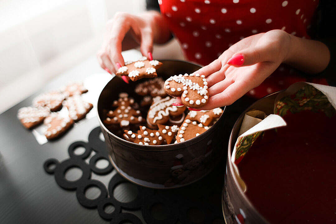 Young Woman Showing Freshly Baked Christmas Cookies