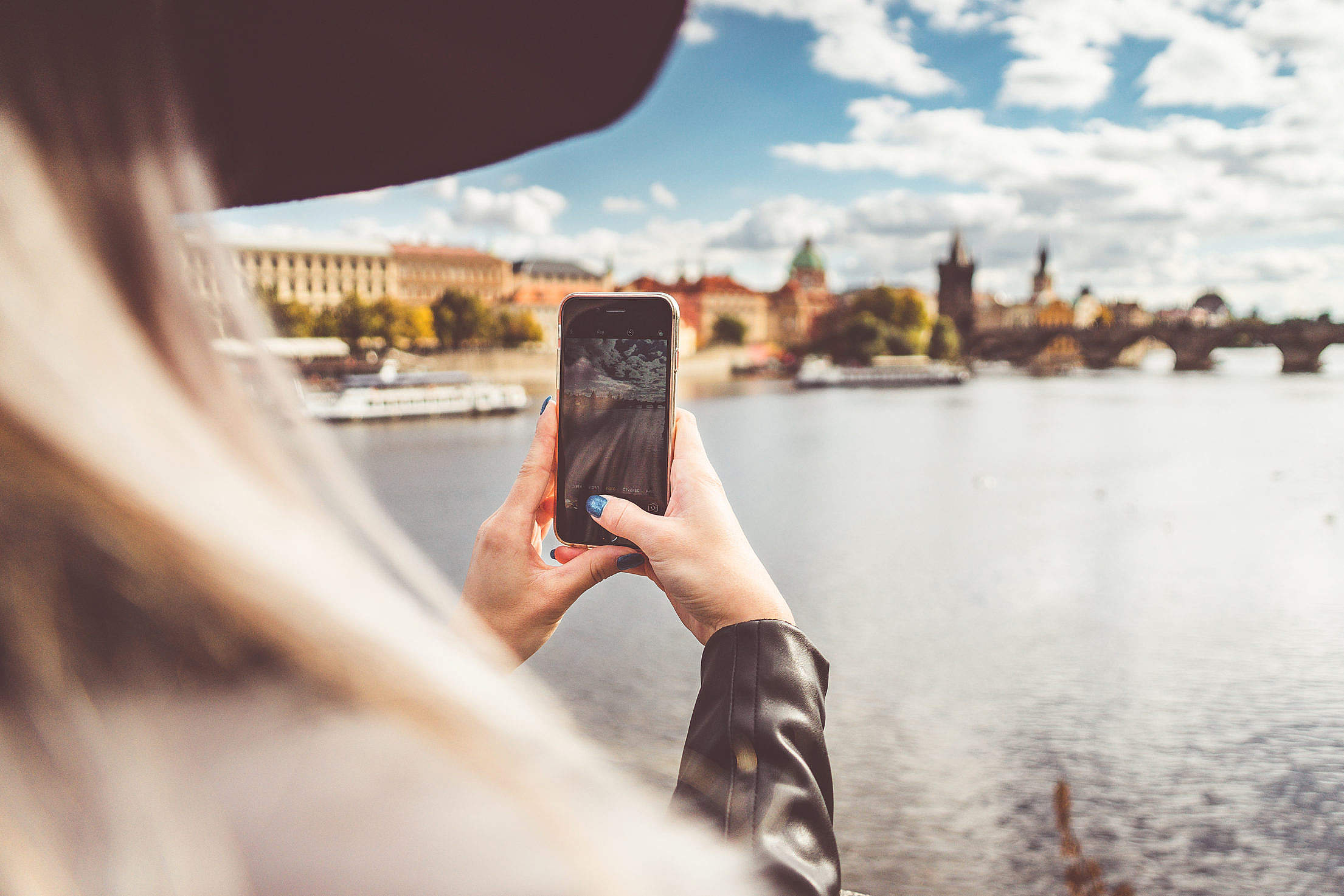 Young Woman Taking a Photo with Her iPhone Free Stock Photo
