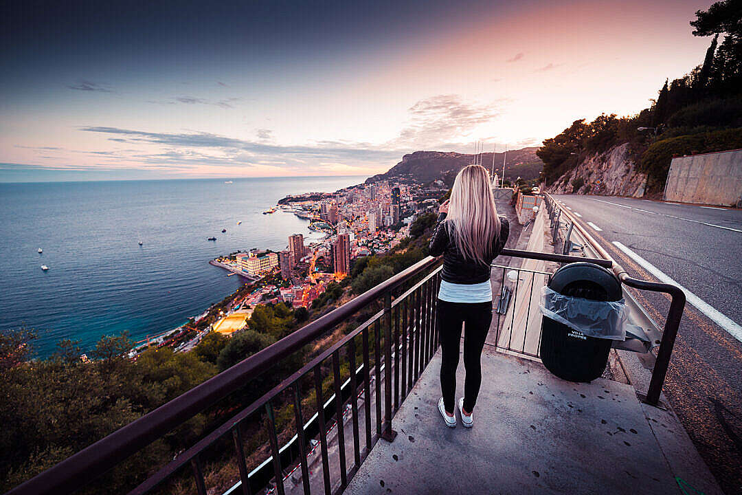 Young Woman Taking a Picture of Evening Monaco