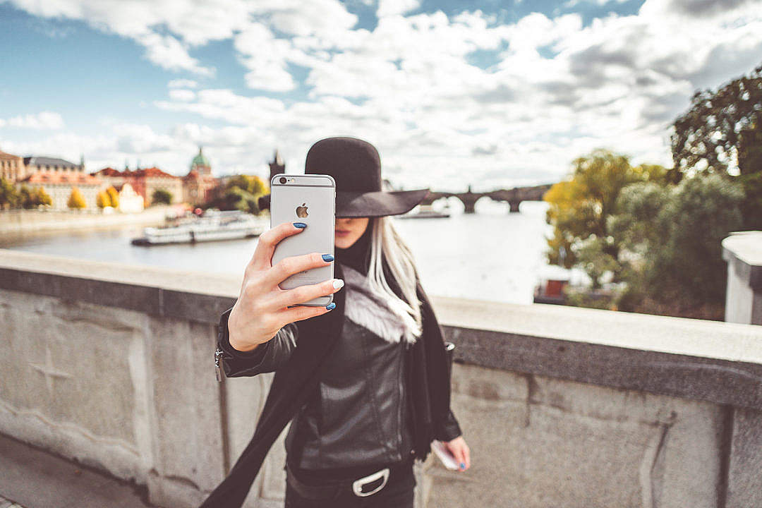 Young Woman Taking a Selfie with Her iPhone