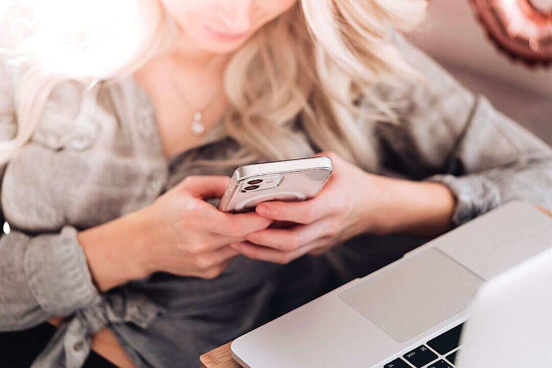 Download Young Woman Using Her White Smartphone at Home FREE Stock Photo