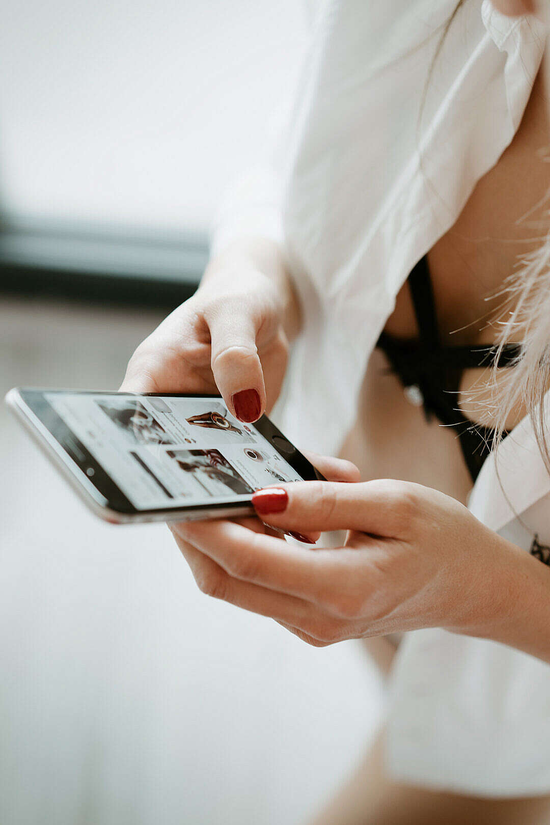 Young Woman Using iPhone in the Morning