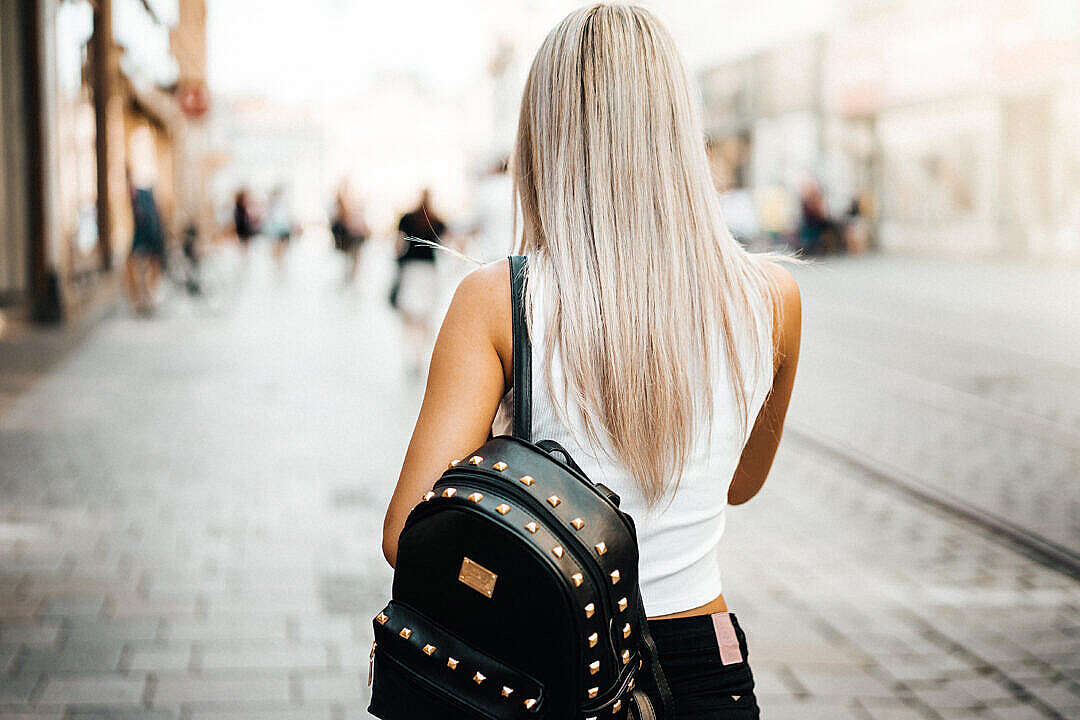 Young Woman Walking on The Street in The City